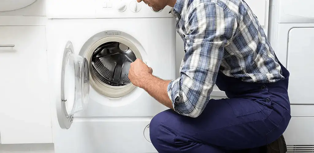Handyman inspecting a dryer drum and internal parts for repair in Dayton, OH