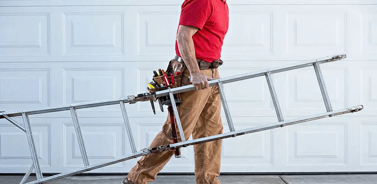 Garage door repair technician arriving with tools and ladder in Dayton, OH
