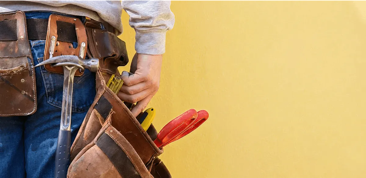 Handyman with tool belt ready for home repairs and maintenance in Dayton, OH