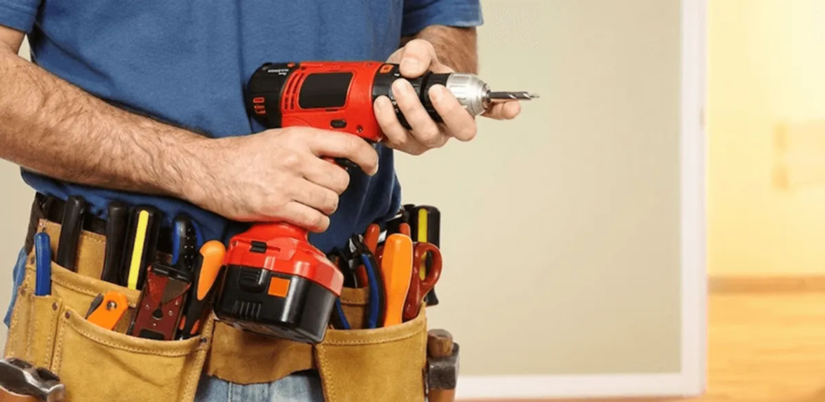 Handyman holding a power drill for home repairs and installations in Dayton, OH