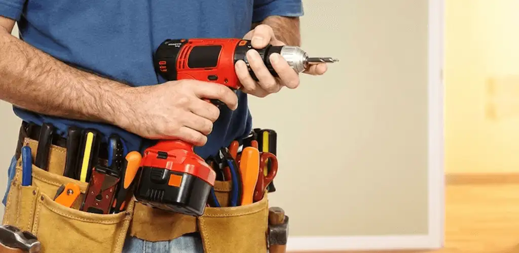 Handyman holding a power drill for home repairs and installations in Dayton, OH